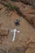1991 Ford Bronco - A rock face displays a metal anchor and a white painted symbol, possibly a trail marker.