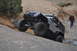 1991 Ford Bronco - A gray Jeep Wrangler JK navigates a rocky trail in a desert landscape.
