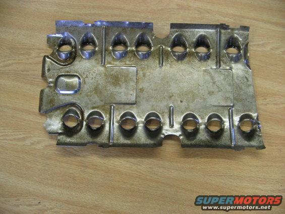 Metal heat shield with multiple stamped holes and some discoloration