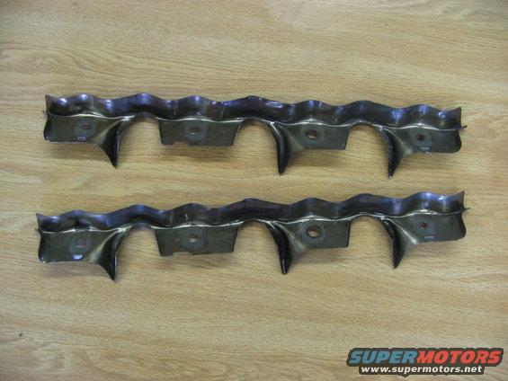 Two wavy metal brackets with pointed tabs, each with two holes