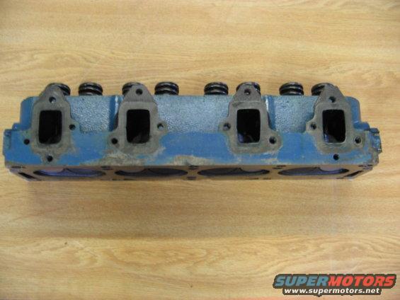 Blue engine cylinder head with four intake ports visible