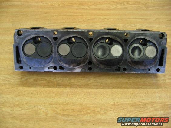 Engine cylinder head with four pairs of intake and exhaust valves visible