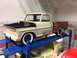 1989 Ford Bronco - Model truck on a lift, with another model vehicle visible underneath.