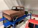 1989 Ford Bronco - Model truck body on a lift with other model vehicles in the background.