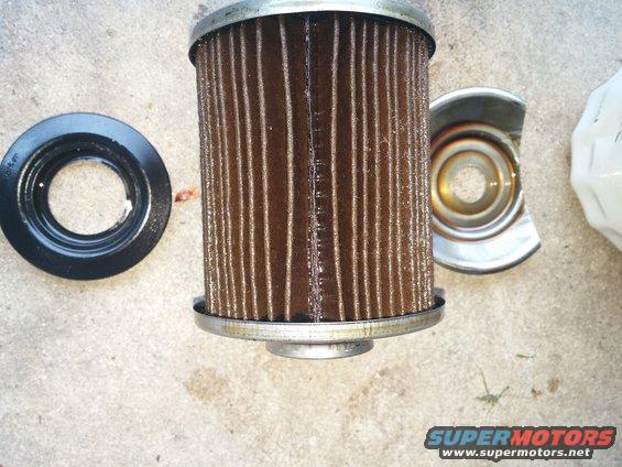 Oil filter and gasket on concrete surface