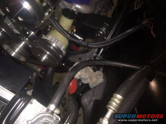 Engine bay showing power steering pump, pulleys, and hoses