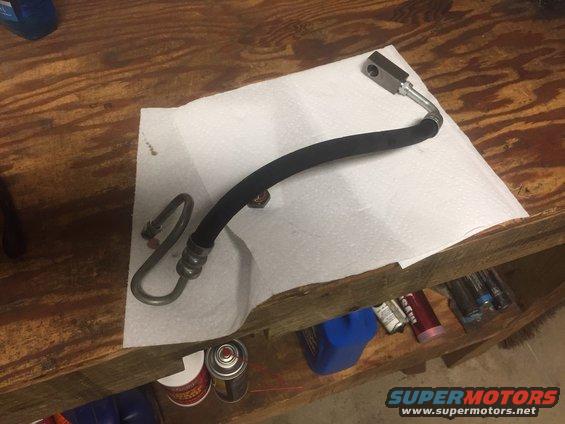 Power steering hose with metal fittings on paper towel
