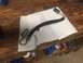 1982 Ford Bronco - A power steering hose lies on a paper towel on a wooden surface.