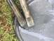 1982 Ford Bronco - Close-up of two splined metal shafts, possibly automotive parts, on a wet surface.