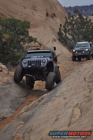 Jeep Wrangler and Ford Bronco driving on a rocky desert trail