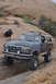 1991 Ford Bronco - This 1991 Ford Bronco navigates rocky terrain, equipped with a light bar for off-road adventures.