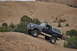 1991 Ford Bronco - This 1991 Ford Bronco is navigating a challenging off-road trail in a desert environment.