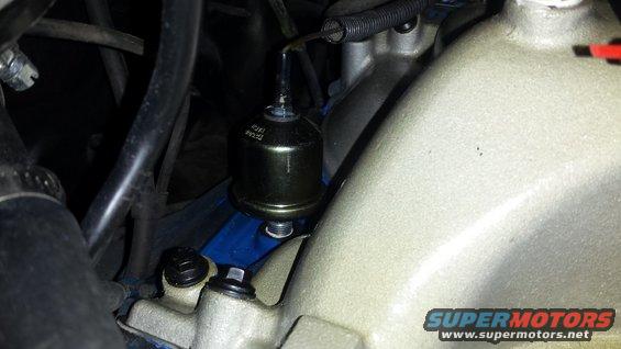 Engine intake manifold with attached component showing text