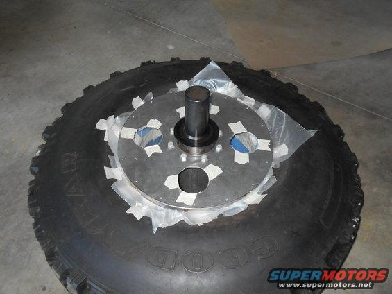 Tire with a metal plate and hub assembly attached, secured with tape