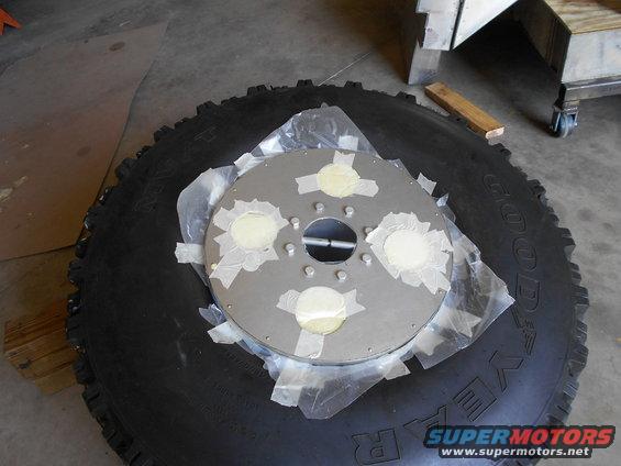 Tire with a metal disc secured by tape and putty