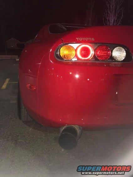 Red 1994 Toyota Supra rear quarter panel with taillights and exhaust pipe