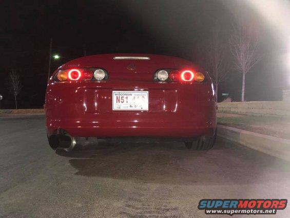 Red 1994 Toyota Supra rear view with illuminated taillights and Wisconsin license plate