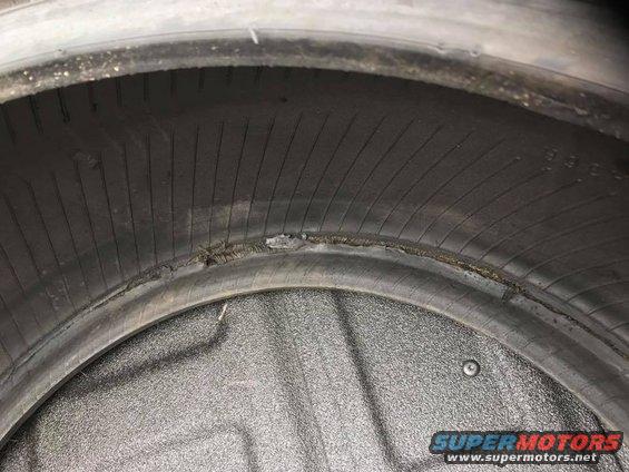 Damaged tire interior with visible wear and tear on the sidewall