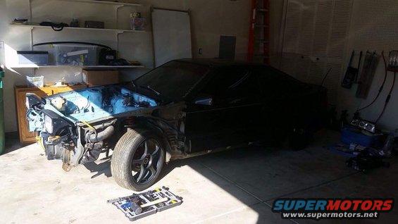 1988 Toyota Celica undergoing front-end repair in a garage