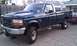 1997 Ford F-250 - This 1997 Ford F-250 pickup truck is seen from a three-quarter front angle, parked in a residential area.