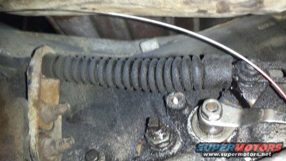 Close-up of a vehicle's parking brake cable and linkage