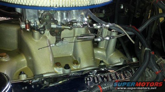 Engine intake manifold with carburetor, throttle linkage, and air filter. Chrome trim reads 'POWER BY'