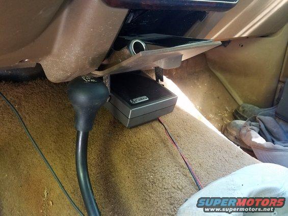 1988 Ford Bronco interior with a black shifter, Cobra CB radio, and tan carpet