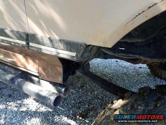 1988 Ford Bronco side view showing lower body trim, dual exhaust pipes, and suspension components