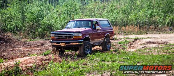 Maroon 1995 Ford Bronco on dirt path