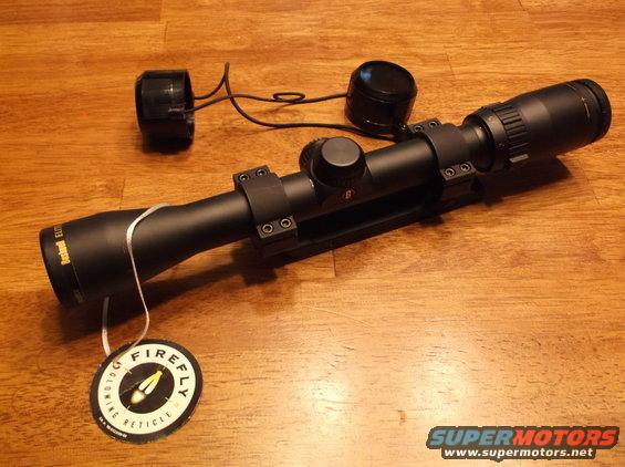 Bushnell Elite rifle scope with lens caps and a "Firefly Reticle" tag