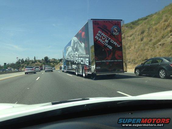 Trailer with 'Factory Five Racing' graphics on highway