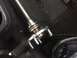 1982 Ford Bronco - Close-up of a vehicle's axle shaft and hub assembly resting on a floor mat.