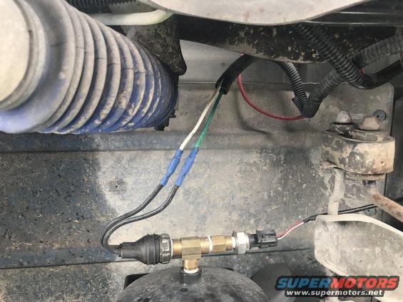Air brake pressure sensor with blue-taped wires and blue corrugated hose