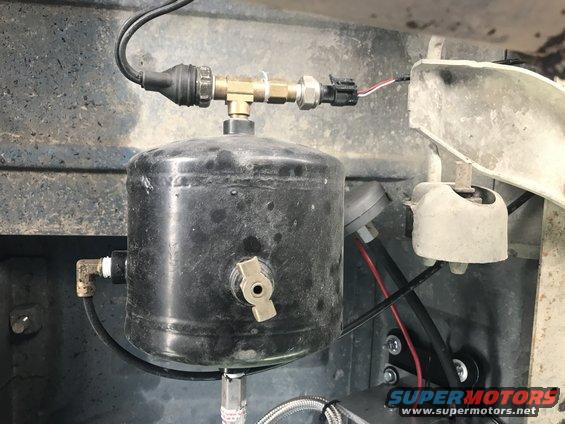 Air compressor tank with brass fittings and electrical connector. Part of an air horn system