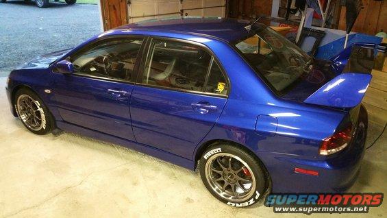 Blue 2006 Mitsubishi Lancer Evolution VIII with large rear spoiler and aftermarket wheels