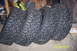 1995 Ford Bronco - Four off-road tires are shown leaning against a wall in what appears to be a garage or storage area.
