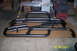 1995 Ford Bronco - Two black steel off-road bumpers are displayed on cardboard in a garage setting.