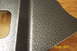 1995 Ford Bronco - A metal part with a textured finish is shown, with a cutout and a raised section visible.