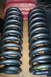 1995 Ford Bronco - Pair of aftermarket suspension coil springs shown on a wooden surface.