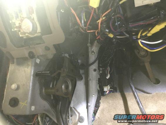 Under dash wiring harness and brake release lever