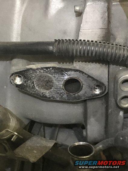 EGR valve gasket surface with bolt holes and circular opening