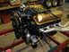 1964 Ford Galaxie - Engine assembly with gold valve covers and silver exhaust headers is mounted on a stand.