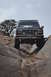 1991 Ford Bronco - This black Ford Bronco navigates a rocky trail with its front end lifted.