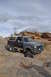 1991 Ford Bronco - This 1991 Ford Bronco is shown off-roading through a , rocky landscape under a cloudy sky.