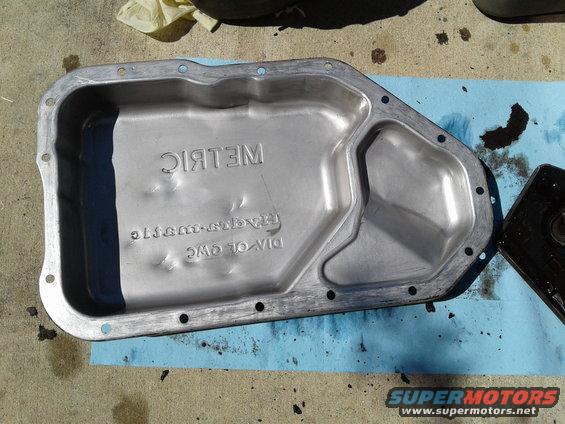 Transmission oil pan with "METRIC" stamped on it, also has "DIV. OF GWC" and "TRANS-SUBARU" stamped