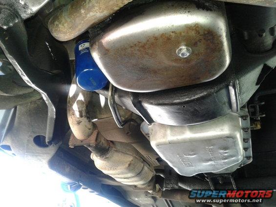 Undercarriage of a car showing oil pan, exhaust, and oil filter