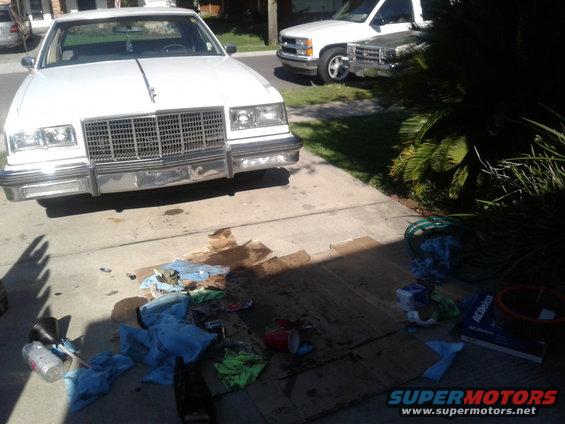 1984 Buick Electra Park Avenue front view, parked in driveway with a white pickup truck behind it