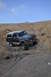 1991 Ford Bronco - This Ford Bronco is navigating a rocky incline under a clear blue sky.