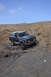 1991 Ford Bronco - Ford Bronco navigates a challenging rocky trail under a clear blue sky.