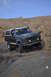 1991 Ford Bronco - This 1991 Ford Bronco navigates a challenging rocky trail under a clear blue sky.